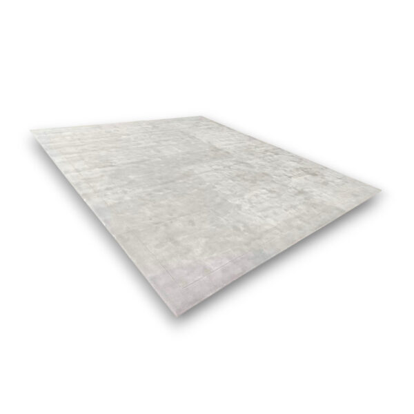 Custom hand-tufted rectangular bamboo silk rug in light gray with subtle mottled texture and visible border trim