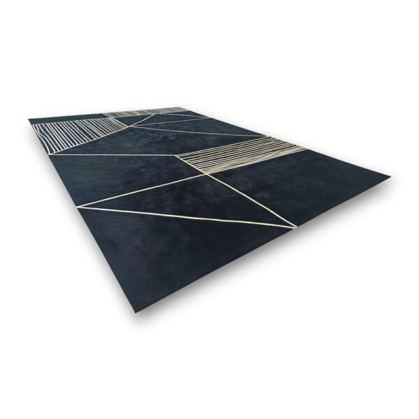 Custom hand-tufted rectangular rug in black with cream geometric lines creating angular triangular sections