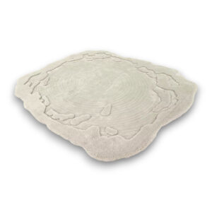 Custom hand-tufted shaggy wool rug in irregular organic shape with cream concentric circle pattern resembling tree rings