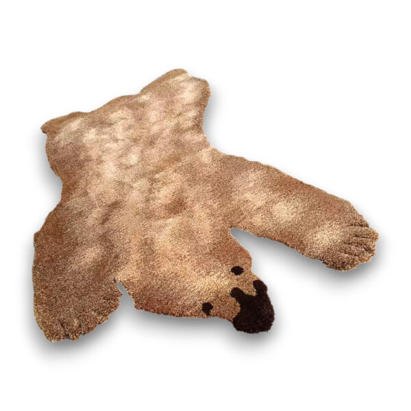 Custom hand-tufted shaggy wool rug shaped like a bear in tan with dark brown facial features