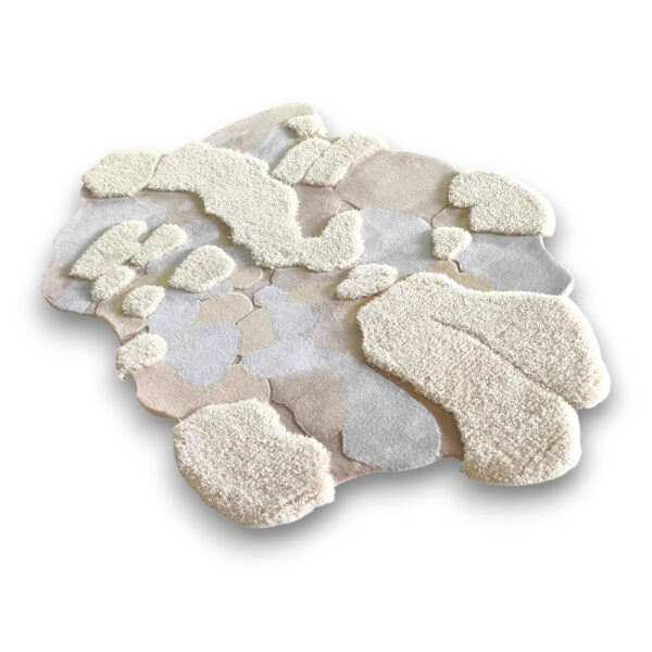 Custom hand-tufted shaggy wool moss rug in organic cloud shape with abstract patches in cream, beige, and gray tones