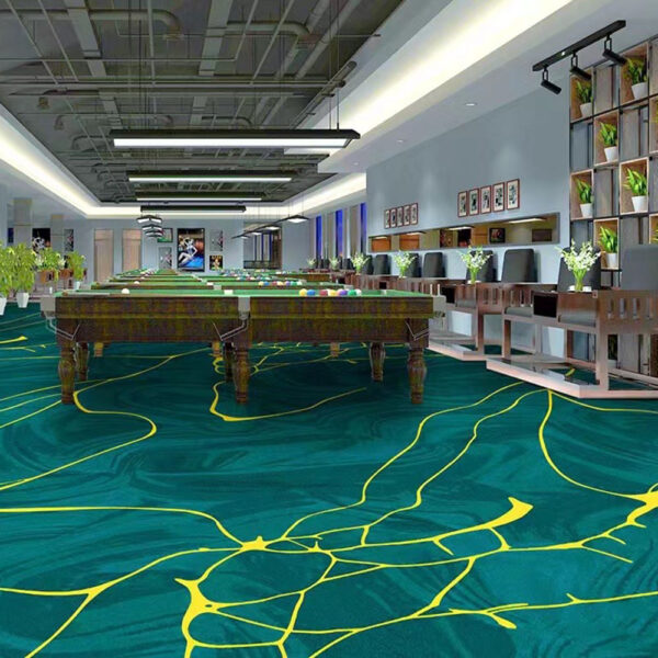 Custom printed large area rug in teal green with yellow curved line pattern installed in recreational center with pool tables and seating areas
