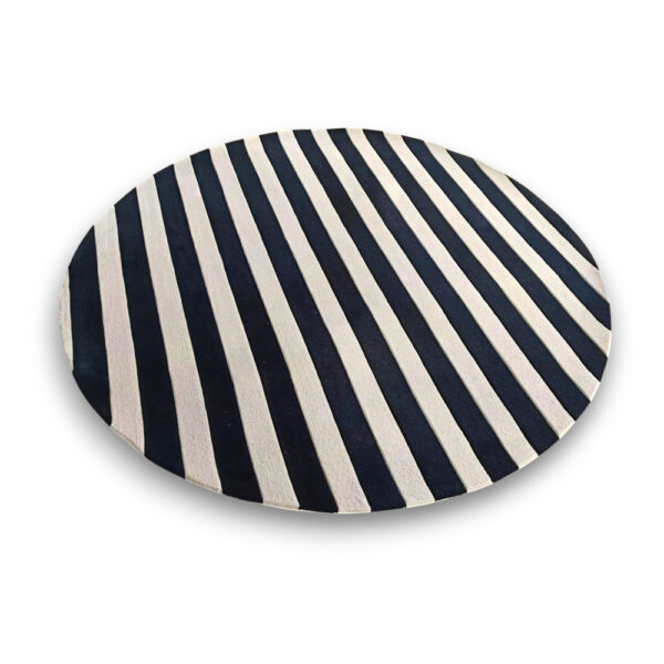 Custom hand-tufted round wool rug in navy black and white with diagonal stripe pattern