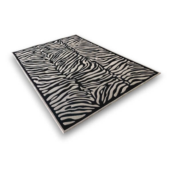 Custom hand-tufted rectangular rug in black and cream with zebra stripe pattern