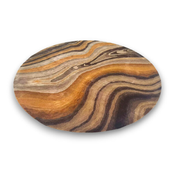 Custom tufted round rug in warm earth tones with flowing wood grain pattern in brown, orange and tan