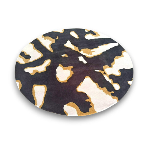 Custom hand-tufted round wool rug in black, gold and cream with abstract camouflage patterns