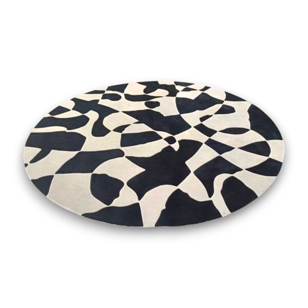 Custom tufted round rug with black and cream abstract organic pattern featuring flowing curved shapes