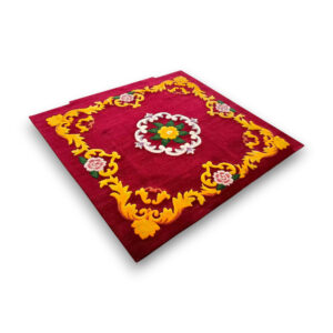 Custom hand-tufted wool rug in deep red with traditional floral medallion center and ornate yellow scrollwork border with pink roses
