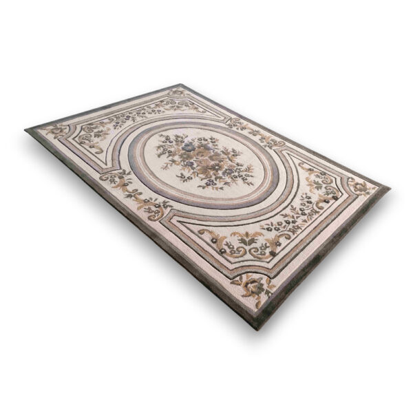Custom tufted vintage wool rug in cream and beige with ornate European-style central oval medallion featuring floral bouquet and decorative scrollwork border
