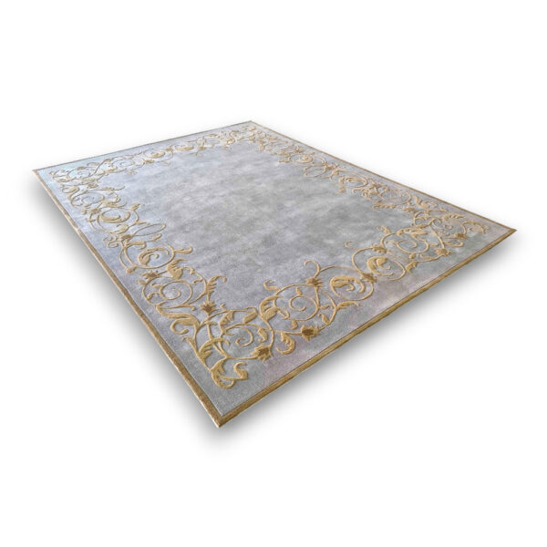 Custom tufted vintage wool rug in gray with ornate gold scrollwork border design and plain center field