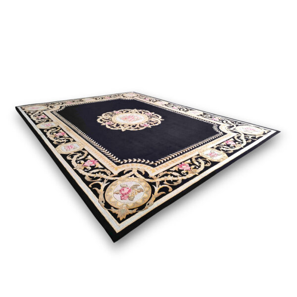 Custom tufted vintage wool rug in navy blue with ornate floral border in cream and gold, featuring central medallion