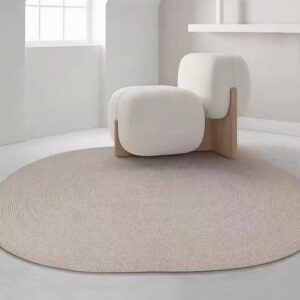 Custom woven gluefree round wool rug in neutral beige with concentric circle pattern placed in minimalist living room